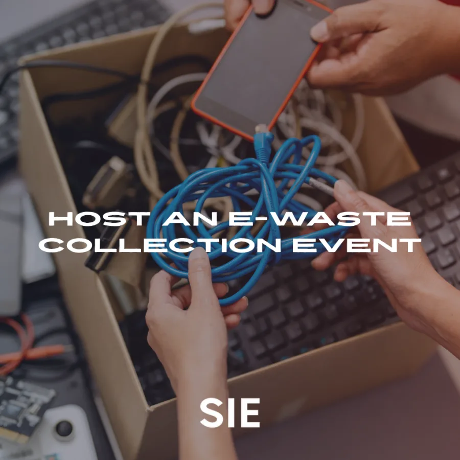 Person sorting through a box of old IT cords and hardware as part of an e-waste collection event to promote responsible recycling.